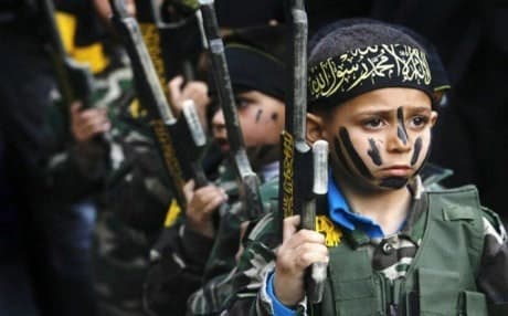 Children line up at an ISIS training camp. AP photo.