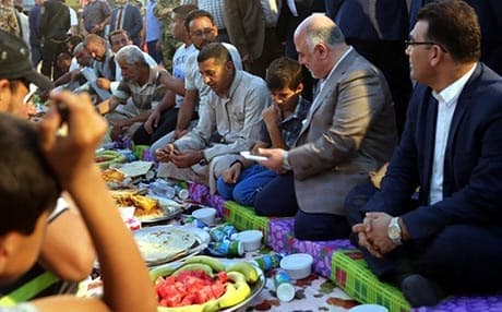 Hiader al-Abadi while breaking the Ramadan fast with refugees. Photo: Rudaw. 