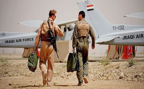 A US Air Force instructor (L) and a student pilot from Iraq’s Flight Instructor School walk to their planes before a mission at Kirkuk Air Base. Photo: US Air Force, 2008