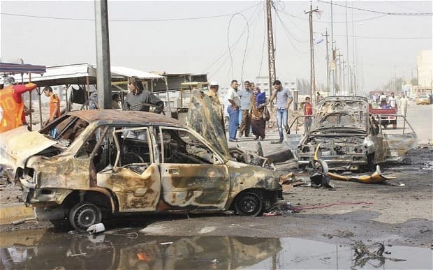 Residents gather at the site of a bomb attack in Iraq last month, part of a period of intense bloodshed in Iraq. AP file photo