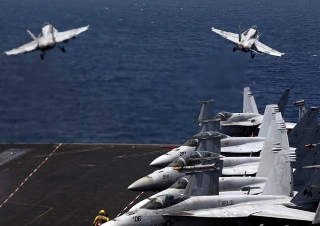 US F/A-18 fighter jets take off for mission. Photo: AP. 