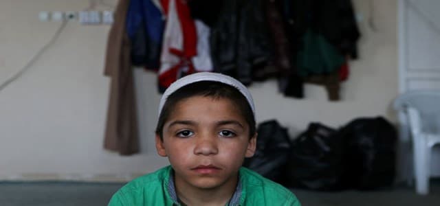 Syrian boy Ahmad, 7, whose parents went missing in Syria, attends a class of religious lessons at an Islamic teaching center designed to counter Islamic State group indoctrination, near the Turkish-Syrian border city of Sanliurfa, southern Turkey. (AP Photo/Hussein Malla)
