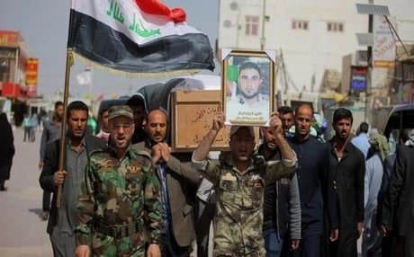 Iraq’s Shiite Badr Brigade, which is backed by Iran, at a funeral for a dead fighter. AP file photo.