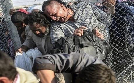  AFP file photo of Syrian refugees bursting across the Turkish border.