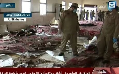 An AFP image grab from the Saudi Al-Ekhbaria TV shows Saudi security forces inspecting the site of Thursday’s explosion. 