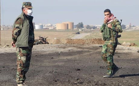 File photo of Kurdish soldiers surveying the site of a bomb attack on a road between Mosul, Iraq, and the Syrian border in northern Iraq.  Photo: Kurdistan Region Security Council.
