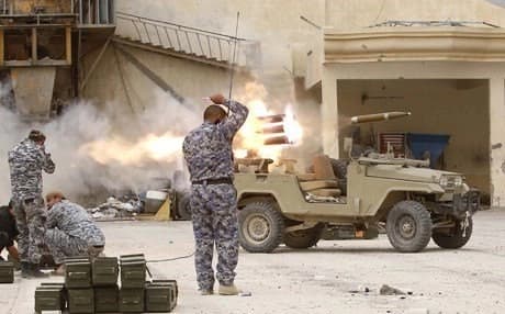  Iraqi forces fire a rocket at the Baiji oil refinery. AFP file Photo. 