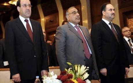 Iraqi Prime Minister Nuri al-Maliki (L) and members of his cabinet listen to the Iraqi national anthem. Photo: AFP