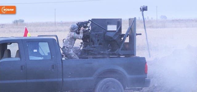 A Peshmerga truck gunner fires rounds at ISIS fighters during Wednesday mass assault across southern Kirkuk province. Photo: Rudaw. 