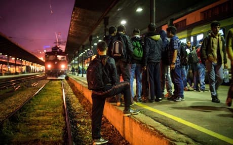 Migrants wait to board a train at Belgrade's main railway station bound for the border with Hungary on June 26, 2015. Hungary, which has seen 60,000 migrants crossing its border this year. AFP file photo