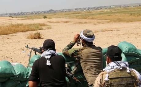 Peshmerga forces and volunteers hold a position south of Kirkuk. AFP file photo.