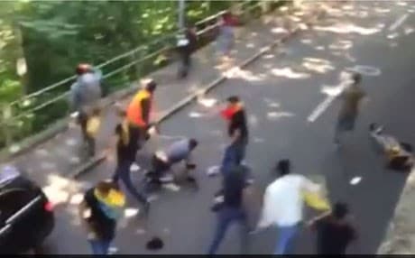 A black Mercedes ploughs through a group of Kurdish demonstrators in Bern. Video from Facebook.