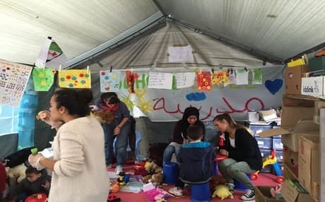 Brussels park welcomes refugees with beds, food and phones to call home 