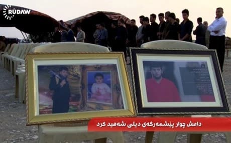 Photos of Barzan Mohammed, one of the beheaded Peshmerga, were displayed at his funeral Saturday in Kirkuk.