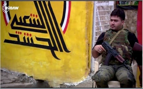 A militiaman guarding the office of the Shiite Hashd al-Shabi in Tuz Khurmatu