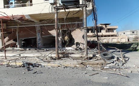  A Peshmerga fighter carefully inspects a building that might have been booby-trapped by ISIS in the city of Shingal. 