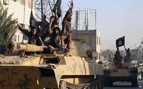 ISIS fighters parade their captured heavy weapons through the Syrian city of Raqqa in June last year. AP file photo.