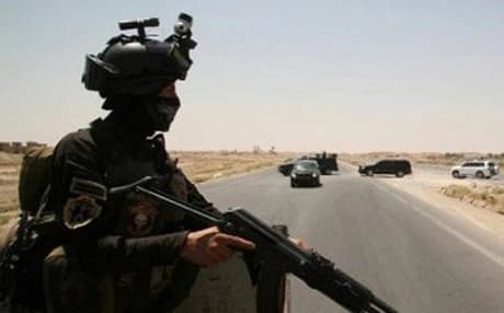  A member of the Iraqi security forces keeps watch on the main highway near Ramadi. AFP file photo 