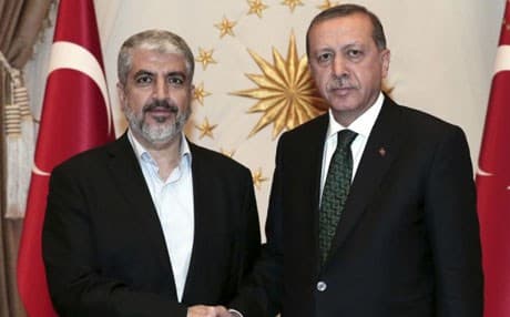 Turkey's President Recep Tayyip Erdogan, right, shakes hands with Hamas leader Khaled Mashal, left. AP file photo. 