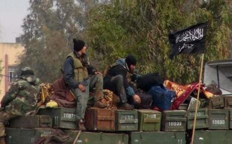 Rebels of Jabhat al-Nusra sitting on an ammunition truck in northern Syria. Photo: AP