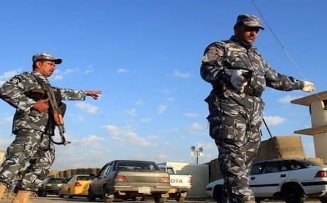 Security officers motion to drivers at Kirkuk's main checkpoint. Photo: AFP/ File photo