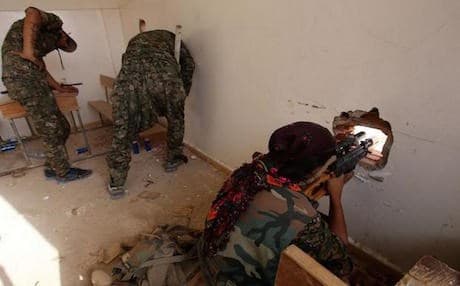 Kurdish YPG fighters battling ISIS from inside a classroom in Hasakah. July 2015. AFP photo