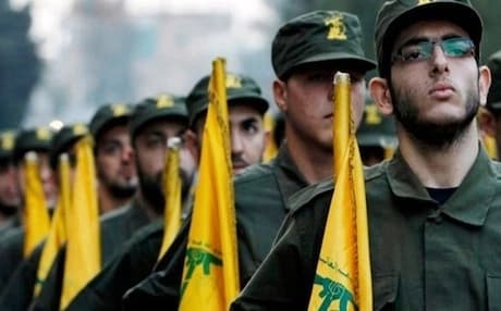Hezbollah fighters march carrying their group's yellow flag. Photo: AP
