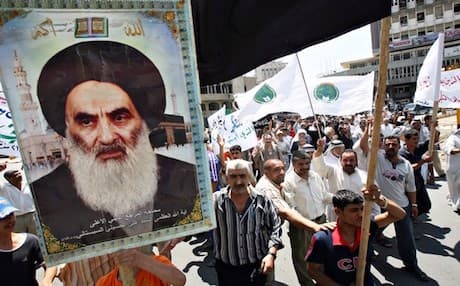 Iraqi Shiites carrying a poster of Ayatollah Ali Sistani. AFP photo
