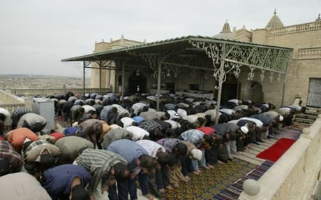 Mosul residents praying at the mosque of Prophet Yunus in 2010. Photo: AFP