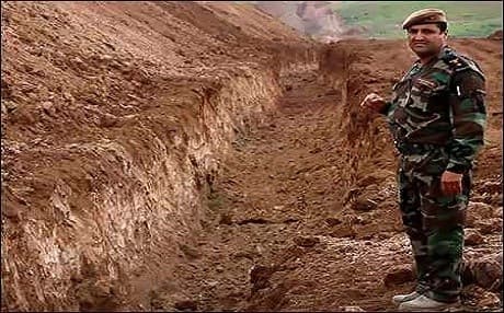A Peshmerga soldier stands by a security trench on the battlefields against ISIS. Photo: AFP.
