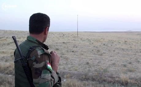  A Peshmerga guard scans the horizon at one of the frontlines. Photo: Rudaw 