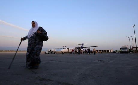 People walking upon their arrival to the Qamishlo International Airport, Syria. Photo: AFP. 