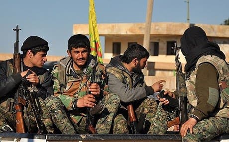 YPG fighters sit in the back of a pick-up truck in north-eastern Syria. AFP  Photo. 