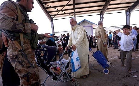 Civilians fleeing Mosul after it was occupied by ISIS in June 2014.  Photo: AP