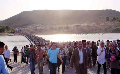 Within 10 days after the bridge crossing over the Peshkhabour river was reopened on August 15, nearly 50,000 refugees – mostly Syrian Kurds – had flooded into Iraqi Kurdistan. Photo: AFP
