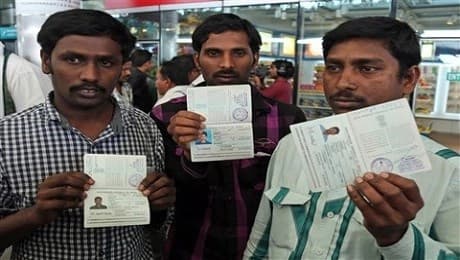 Some Indian workers showing their passports to the media after escaping from Iraq back to India in July 2014. Photo: AP