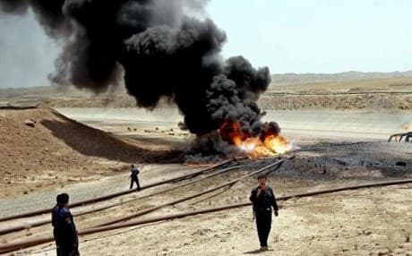 Members of the oil protection police secure the site of a burning oil pipeline near the northern city of Kirkuk, 03 July 2006. AFP File Photo. 