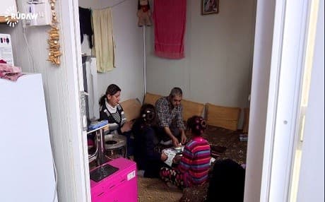A Christian refugee family enjoys a modest Easter meal at the Dawdia camp
