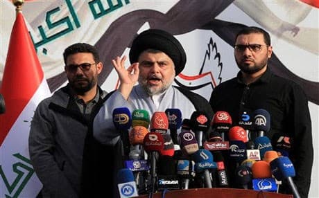 Shiite cleric Muqtada al-Sadr speaks to a gathering of supporters before entering the highly fortified Green Zone in Baghdad, Iraq. AP photo.  