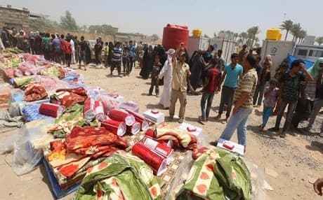 Displaced civilians from Ramadi waiting to receive humanitarian aid from the UN. AP photo. 