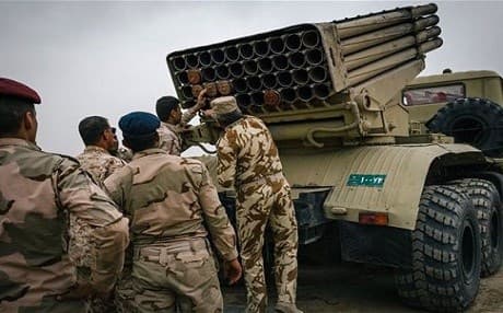 Iraqi army soldiers load a rocket launcher outside Makhmour. Photo: AP