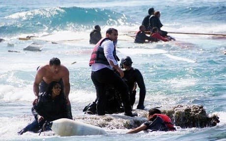 AP file photo of rescue team helping a migrant after a boat sank off the Turkish-Greek water routes. 