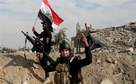 Iraqi security forces raise an Iraqi flag in Anbar province. Photo: AP 