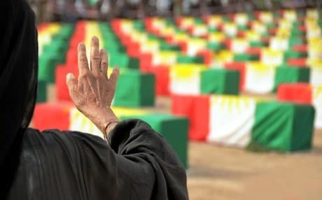 A Kurdish woman survivor of the Anfal genocide campaign greets the remains of Anfal victims returned to the Kurdistan Region after more than two decades