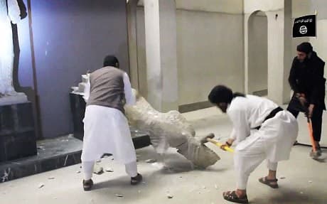 Islamic State militants take sledgehammers to an ancient artifact in the Ninevah Museum in Mosul in February, 2015 . AP Photo 