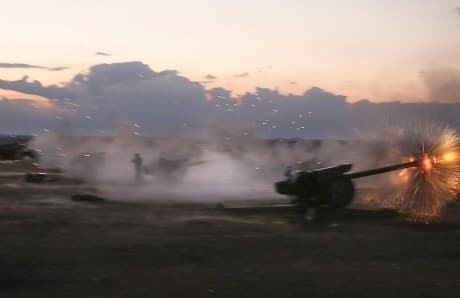 Syrian howitzer artillery guns in action. AP Photo. 
