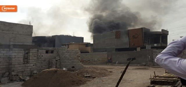 A column of smoke rises at the site of a military clash inside Khurmatu.