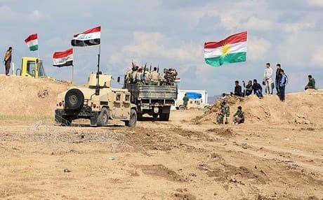 Iraqi Army vehicles pass through Kurdish Peshmerga forces on their way to the Makhmour front. Photo: Farzin Hassan, Rudaw.