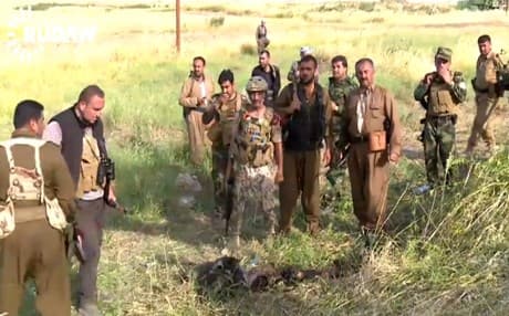 A number of kurdish peshmerga standing in a field near Tel Skof shortly after last Tuesday's fighting with members of the Islamic State. Photo: Rudaw