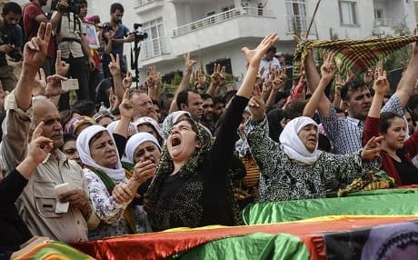 Mourners attend a funeral of 21 killed during a curfew in Cizre in September 2015. Photo: Ilyas Akengin/AFP